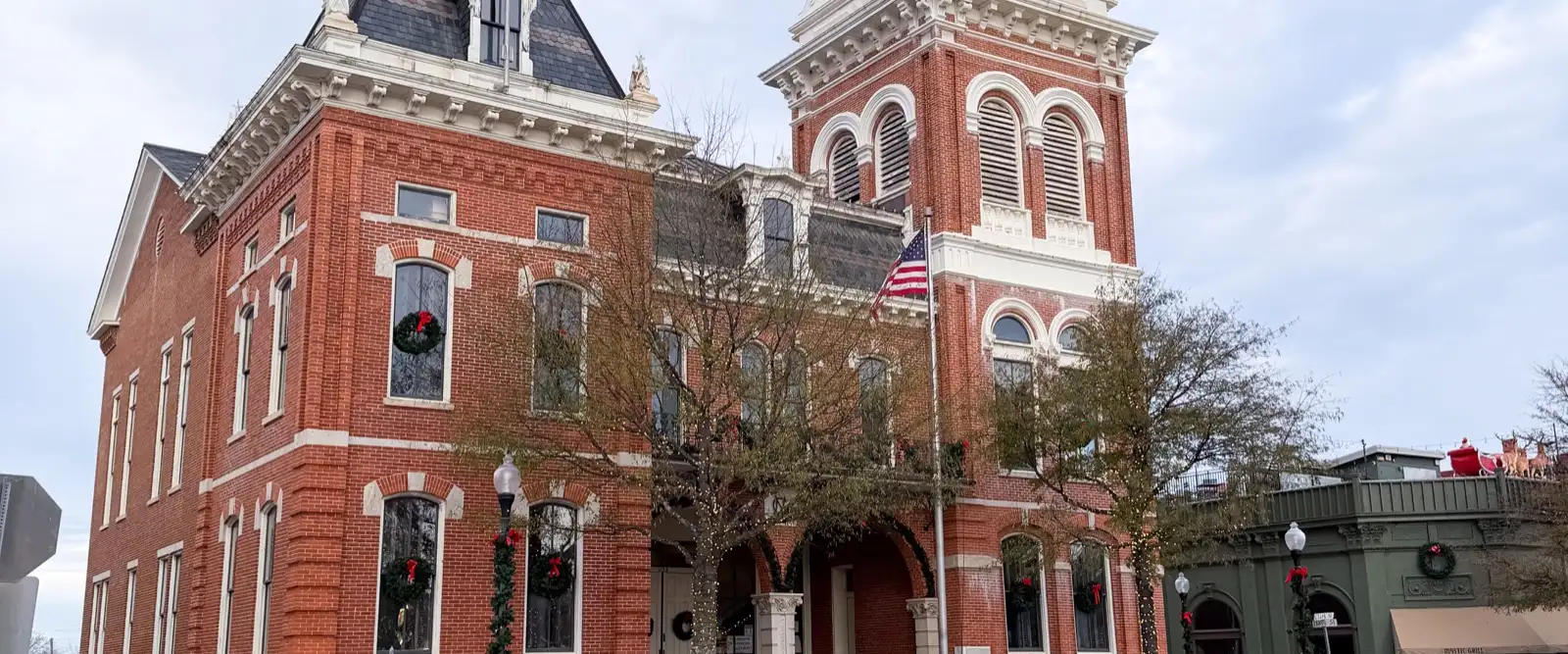 The red-brick courthouse and white clock tower on the Covington, Georgia town square, filmed as Mystic Falls.